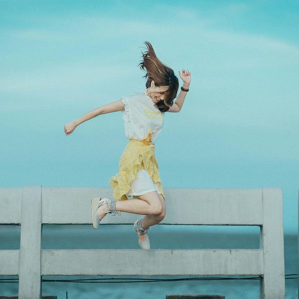 Woman feeling energetic and happy outdoors in the sun.